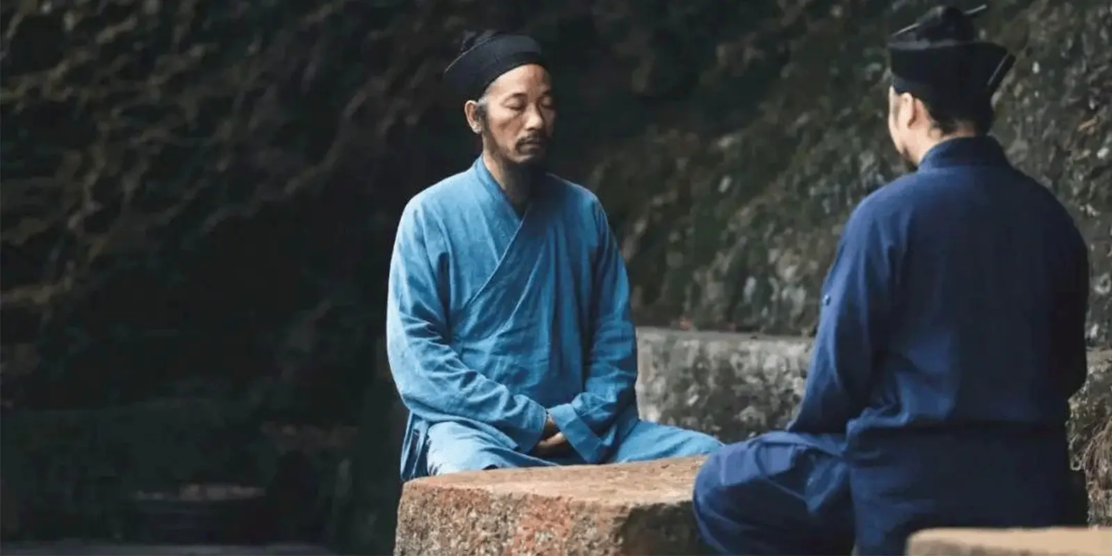 Two Taoist priests meditating face-to-face in a serene mountain landscape, representing the ancient Eastern wisdom tradition that powers the modern AI Spiritual Oracle by 69player.